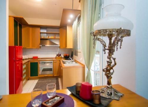 a kitchen with a table with a lamp on it at Luxury Chez-Moi in Serres