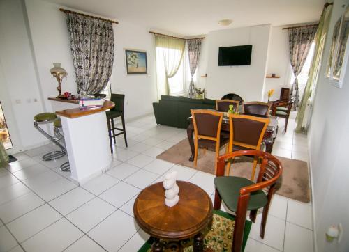 a living room with a table and chairs at Luxury Chez-Moi in Serres