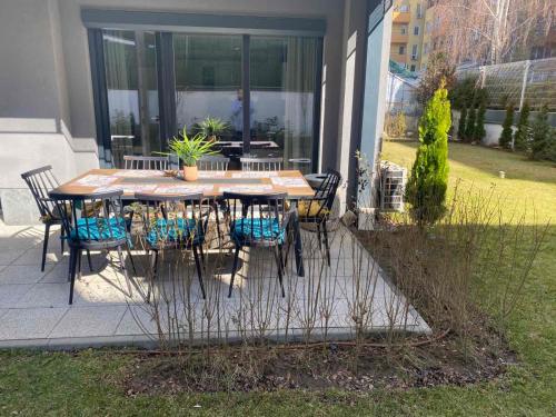 a patio with a table and chairs in a yard at 7th Sense boutique apartments in Sofia