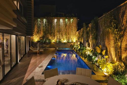 a pool in the middle of a building at night at Tintto Hotel in Fortaleza