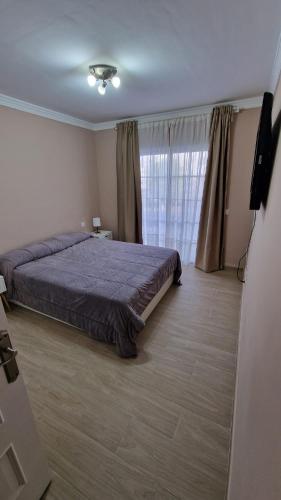 a bedroom with a bed and a large window at CASA LORY in Playa Blanca