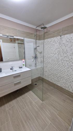 a bathroom with a shower and a sink and a mirror at CASA LORY in Playa Blanca