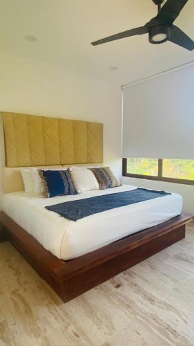 a bedroom with a large bed with a large window at Luana suites- Suite Nikté in Zihuatanejo
