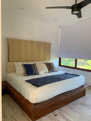 a bedroom with a large bed with a large window at Luana suites- Suite Nikté in Zihuatanejo