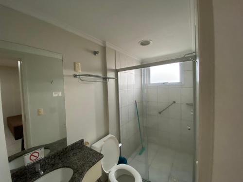 a bathroom with a shower and a toilet and a sink at Locação Caldas Novas 1105 in Caldas Novas