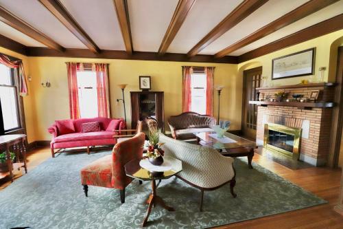 a living room filled with furniture and a fireplace at The Marshall House in Niagara Falls