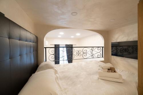 a bedroom with a large white bed with a mirror at POPOLO PEN 56 Apartament in Rome