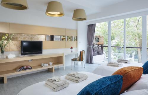 a hotel room with two beds and a television at Around The Tree Manor in Shitan