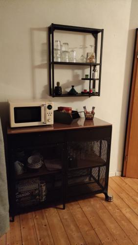 a microwave sitting on top of a table at Apart of "MET" in Mellrichstadt