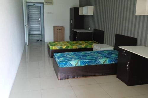 a room with two beds in a room with a counter at Studio House Kampar in Kampar