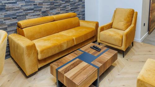 a living room with a couch and a chair at Aparthotel Poljice in Jahorina