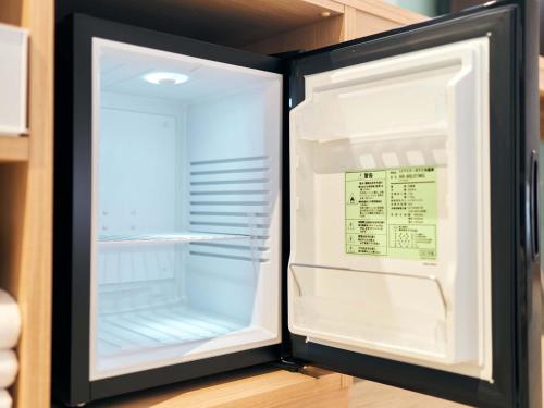 an empty refrigerator with its door open in a kitchen at Rakuten STAY naha-tomarifuto 7F Twin Room in Naha