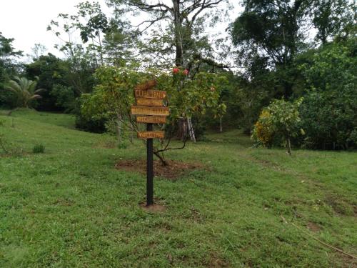 a sign in the middle of a field at Finca Sueno de Osa in Puerto Jiménez