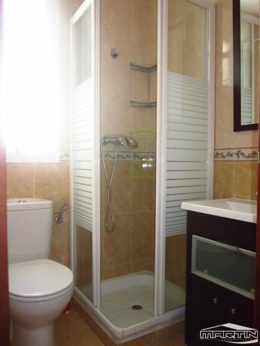 a bathroom with a shower and a toilet and a sink at Apartment Quintana Center Parking Gratis in Lucena