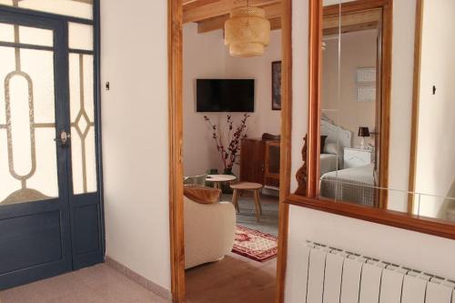 a room with a mirror and a bedroom with a bed at Casa Rural Tío Samuel 