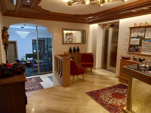a living room with a table and chairs in a room at Hotel Garni Erler in Mayrhofen
