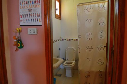 a small bathroom with a toilet and a sink at Farida Apartments in Luxor