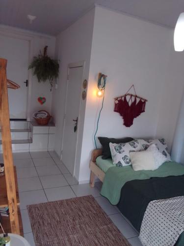 a bedroom with a bed and a hallway with a staircase at Jardim Urbano Cambará do Sul in Cambara do Sul