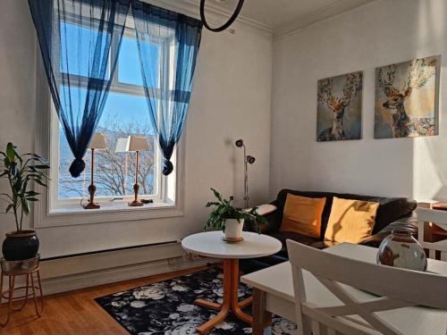a living room with a couch and a window at Cozy, Central, Ocean View in Ålesund
