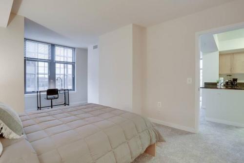 a white bedroom with a bed and a window at Prime Location Retreat Close to DC and Metro in Arlington