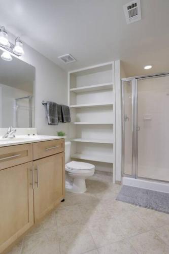 a bathroom with a shower and a toilet and a sink at Prime Location Retreat Close to DC and Metro in Arlington