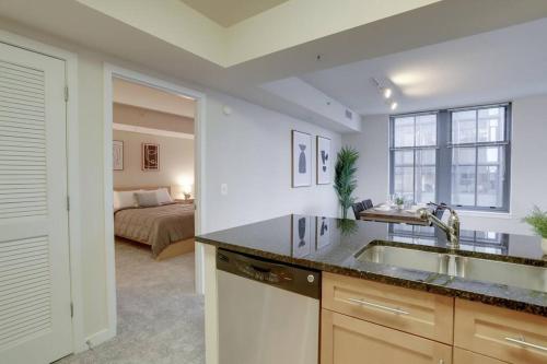 a kitchen with a sink and a bed in a room at Wonderful 2 BR Condo At Pentagon City with Gym in Arlington