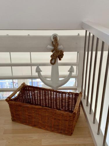 a ceiling fan with a basket and an anchor on it at Tanis Ocean Loft in Martinšćica