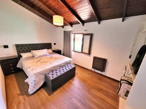 1 dormitorio con cama y sofá en Casa en San Carlos de Bariloche en San Carlos de Bariloche