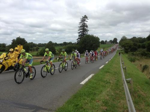 a large group of people riding bikes down a road at Le Bois Gautier in Savigny-le-Vieux