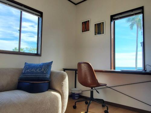 a living room with a chair and a desk at Ocean View Kamogawa - Vacation STAY 61073v in Kamogawa