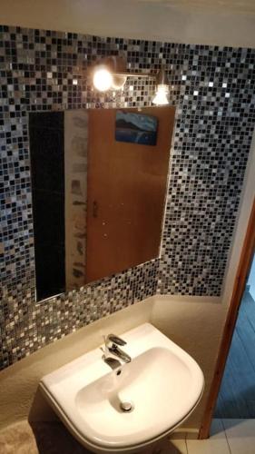 a bathroom with a sink and a mirror at Braxos A beautiful rocky place in Hydra