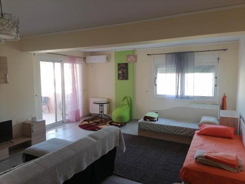 a large room with two beds and a window at Treasure star B&b in Salamina