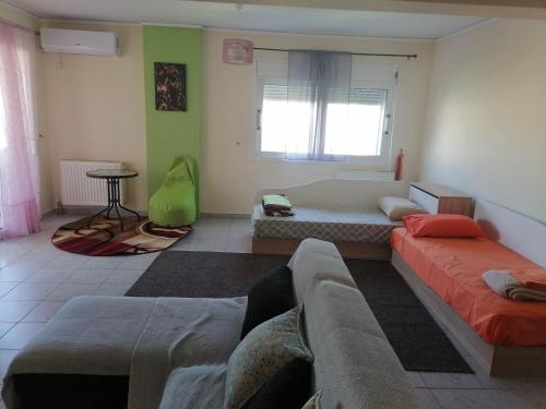 a living room with two beds and a couch at Treasure star B&b in Salamís