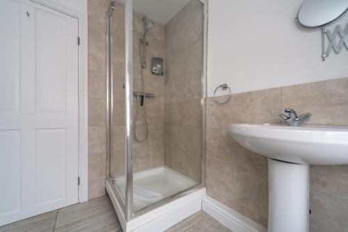 a bathroom with a shower and a sink at Homely 1BD Apt with Free Street Parking in Scunthorpe