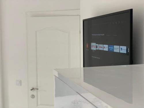 a flat screen tv sitting on top of a white wall at Villa Perla di Mare in Kranevo