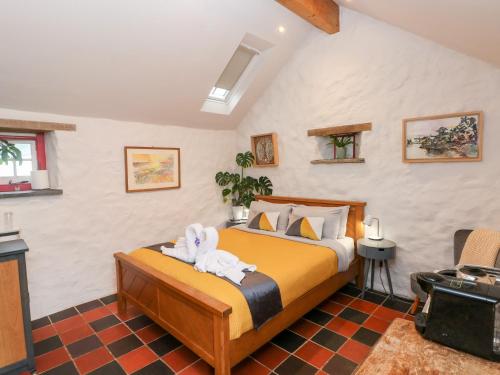 a bedroom with a bed with towel animals on it at The Old Dairy in Pembroke