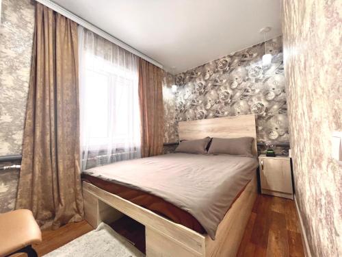 a bedroom with a large bed in a room at Sport Hotel Terra in Ustʼ-Kamenogorsk