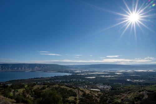a view of a lake with the sun in the sky at Jacob Ohalo Kinneret in Kinneret