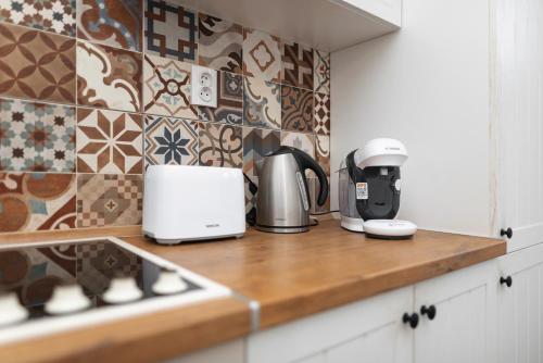 a kitchen counter with appliances on top of it at Apartmány Kašper in Levoča
