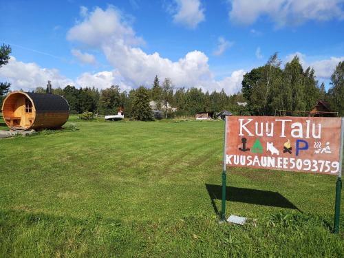 a sign in the middle of a field with a kiwi house at Kõrtsimaja in Myza Kastre