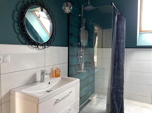 a bathroom with a sink and a shower with a mirror at Malanówka 1 