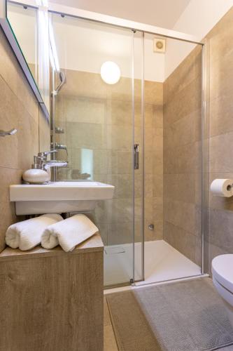 a bathroom with a shower and a sink at Apartments House Barbara in Kornić