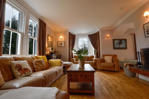 a living room with a couch and a table at Cologin Farmhouse in Oban