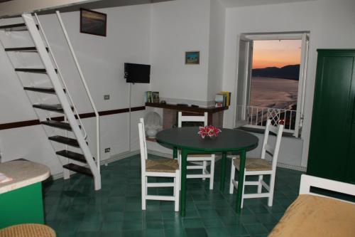 a living room with a table and chairs and a desk at Florenza Residence in Sperlonga