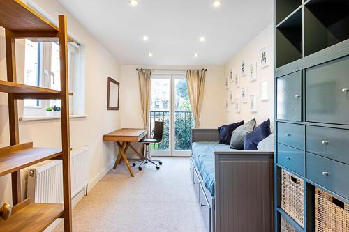 a bedroom with a bed and a desk in it at Lovely Camberwell House in London