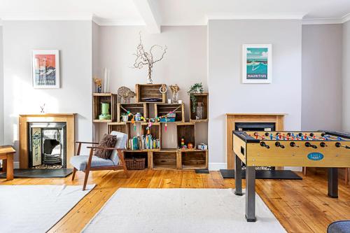 a living room with a foosball table in the middle at Lovely Camberwell House in London