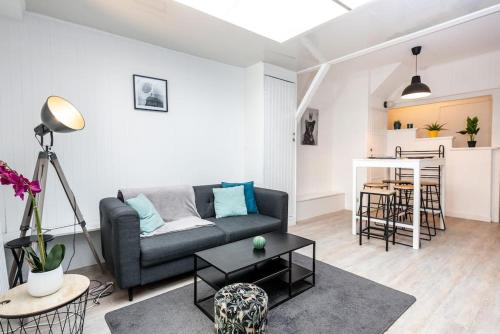 un salon avec un canapé et une table dans l'établissement Uniq Home, à Amiens