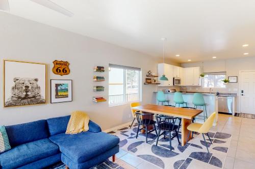 a living room with a blue couch and a table at The Pine House in Flagstaff