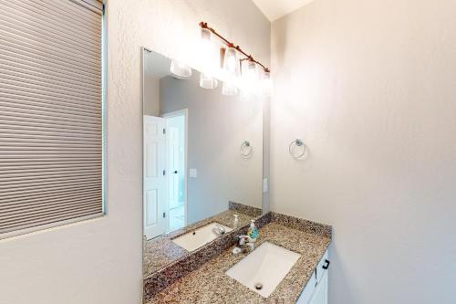 a bathroom with a sink and a large mirror at The Pine House in Flagstaff