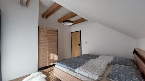 a bedroom with a bed and a wooden door at Chalet Prestige in Stará Turá